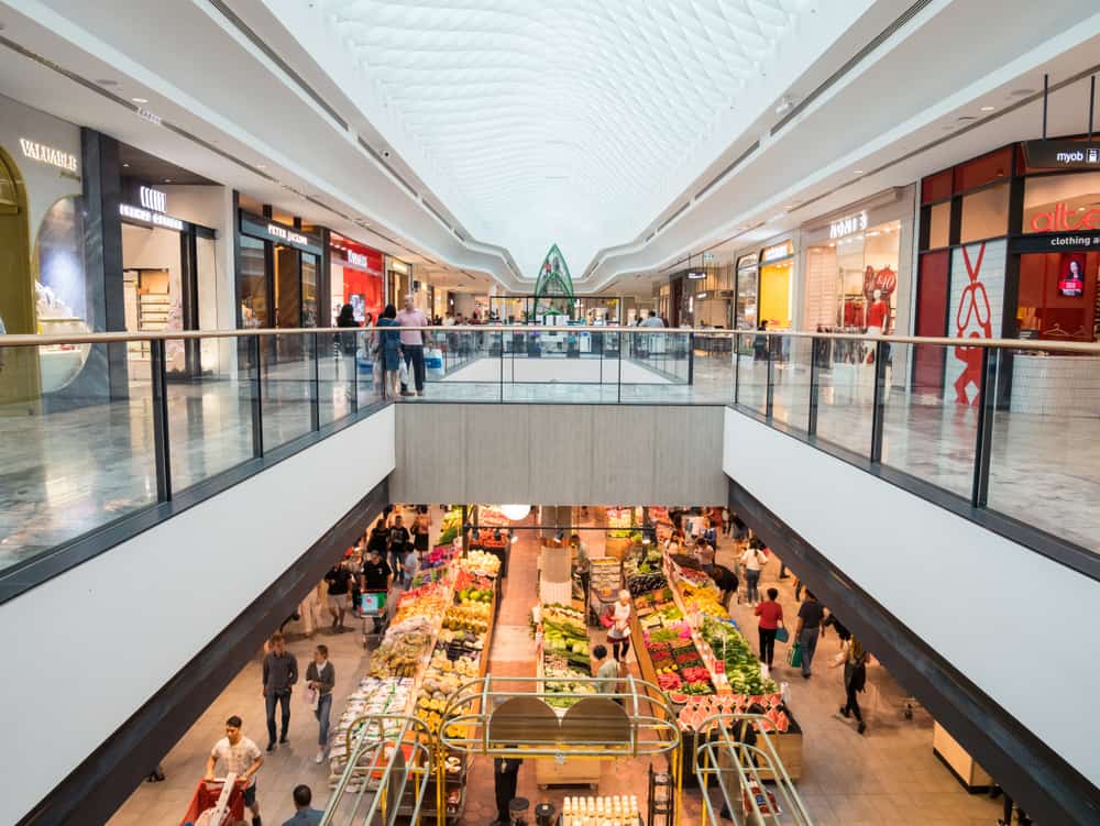 two level shopping mall with fruits and vegetables on the first floor and shopping center on the second floor